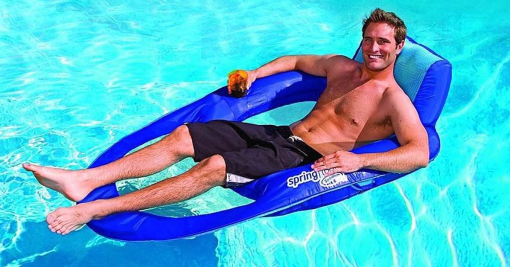 man floating on a swimways inflatable recliner