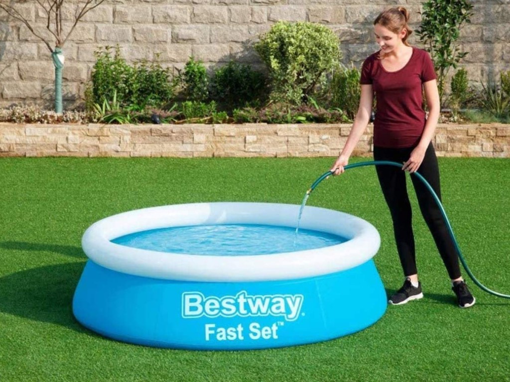 woman filling up inflatable pool