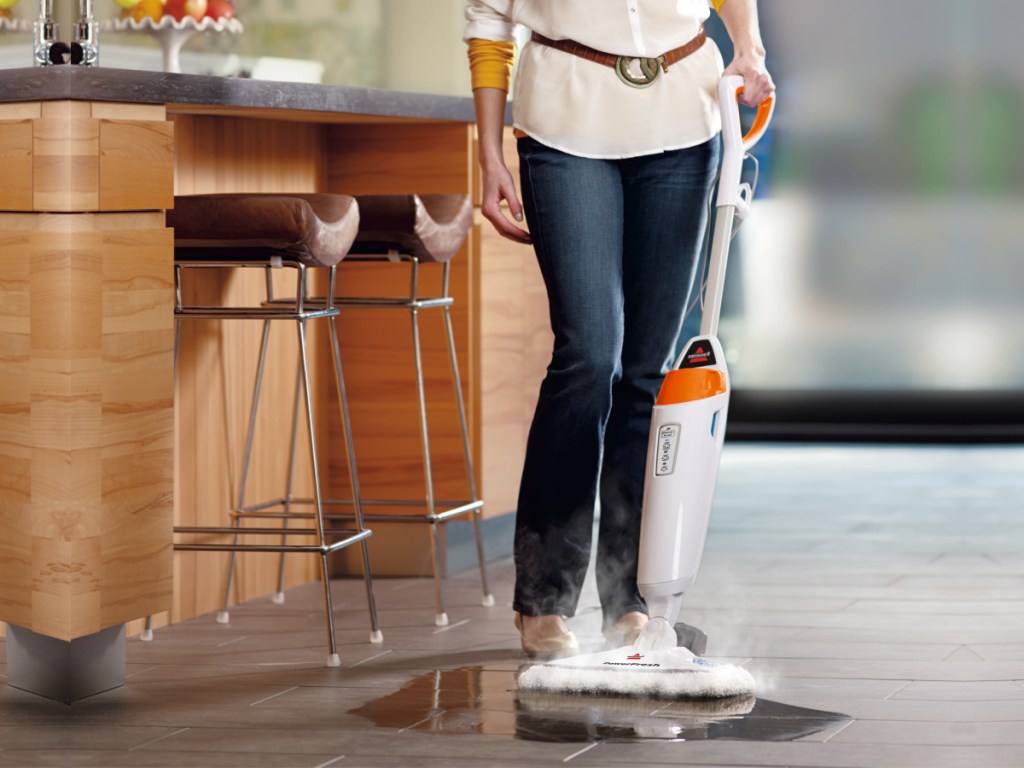 woman pushing a bissell steam mop 