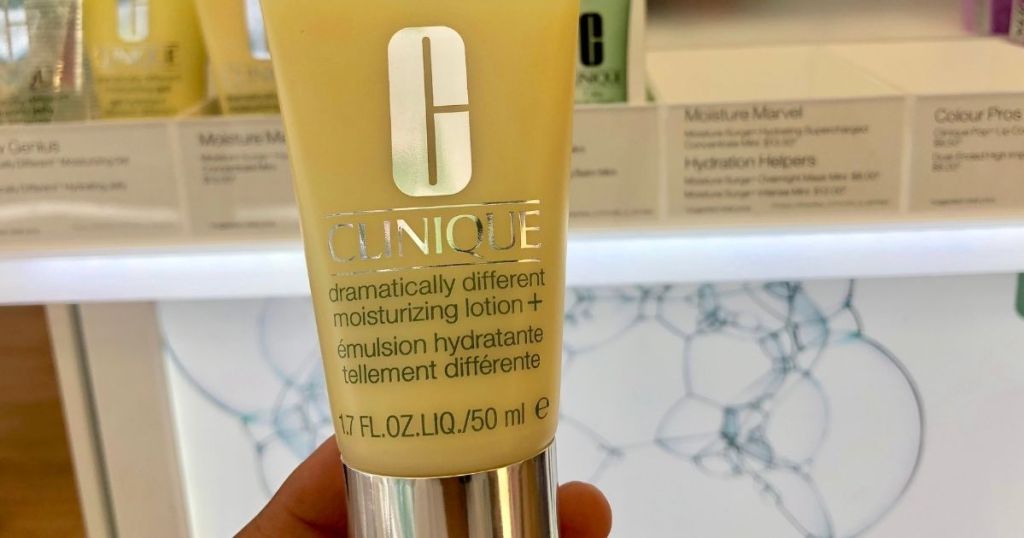 hand holding a Clinique Dramatically Different lotion
