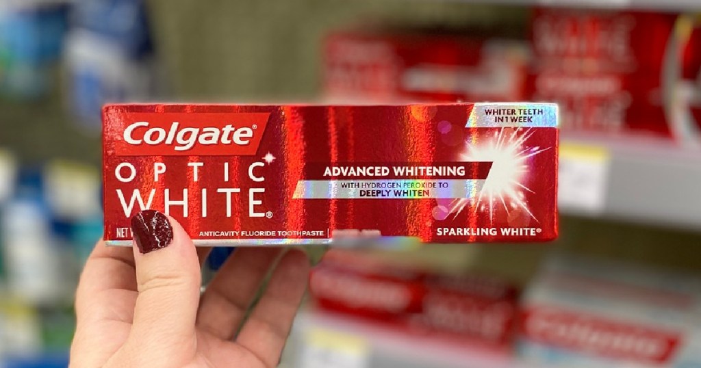 hand holding colgate optic white toothpaste