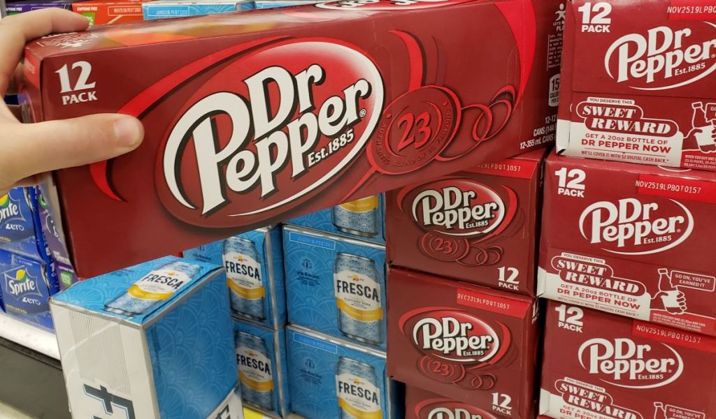 hand holding a 12-pack of Dr. Pepper