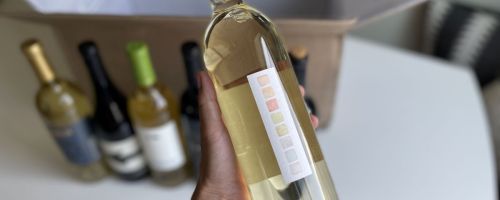 hand holding a bottle of wine