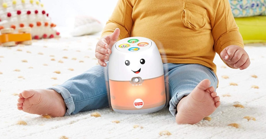 baby playing with Fisher Price Wobble Hub