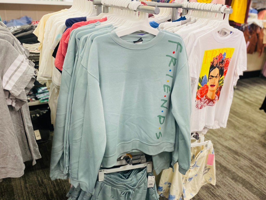 blue sweatshirt with friends on it hanging in store