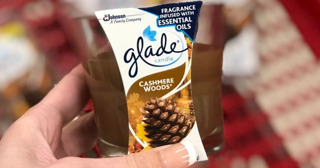 hand holding a Glade Cashmere Woods Candle