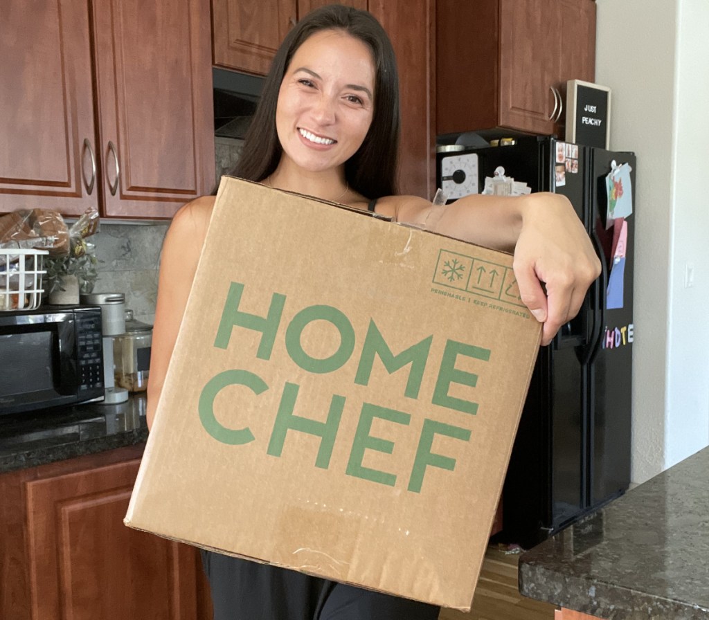woman holding large meal deliver box