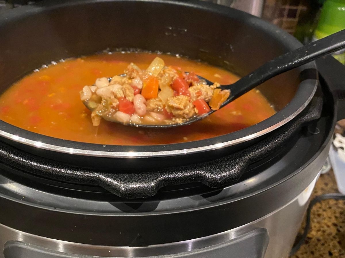 soup in ladle above pressure cooker