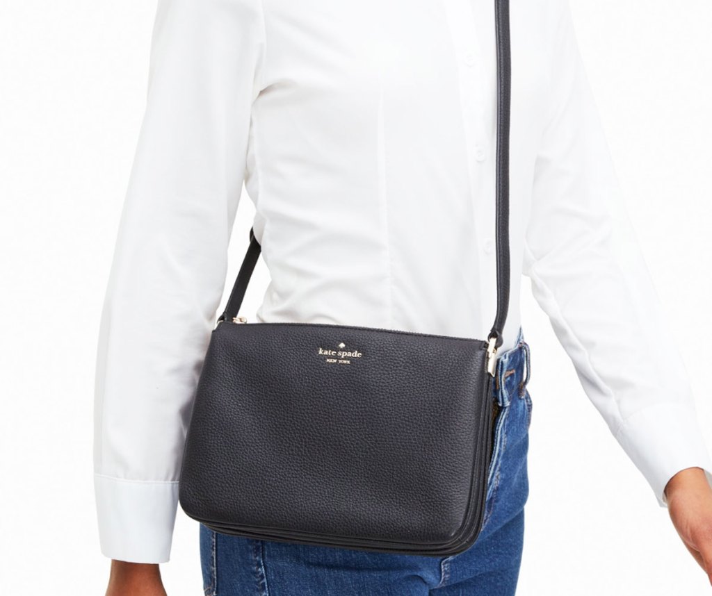 woman wearing black kate spade crossbody bag