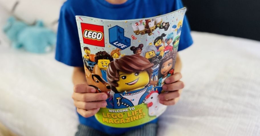 boy holding a LEGO magazine