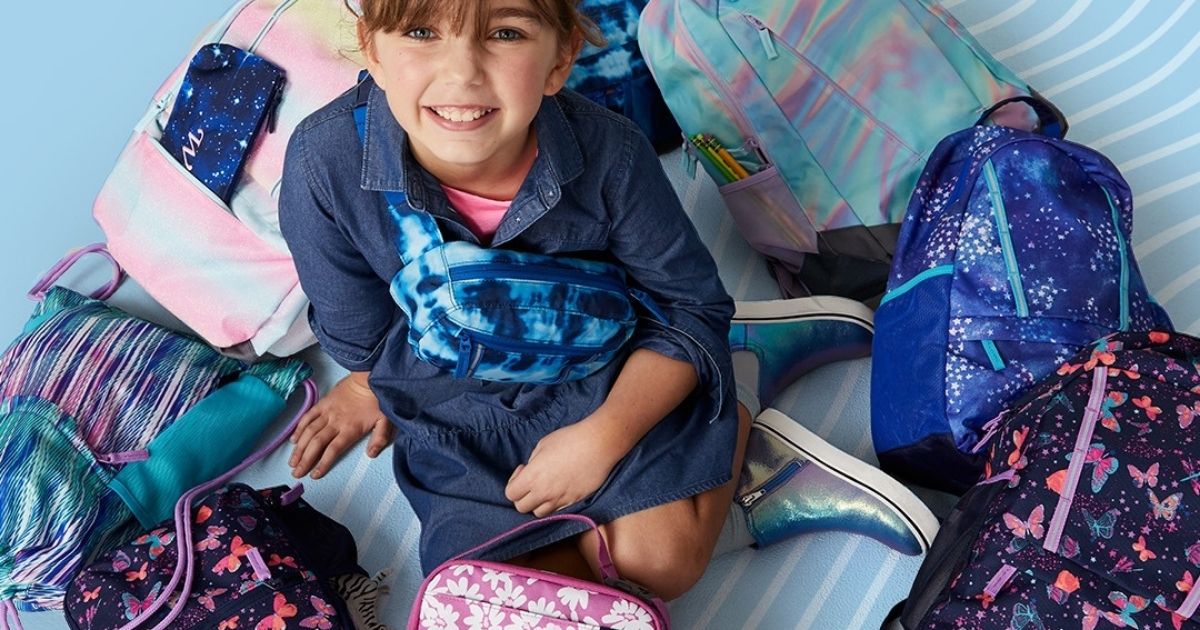 girl surrounded by backpacks