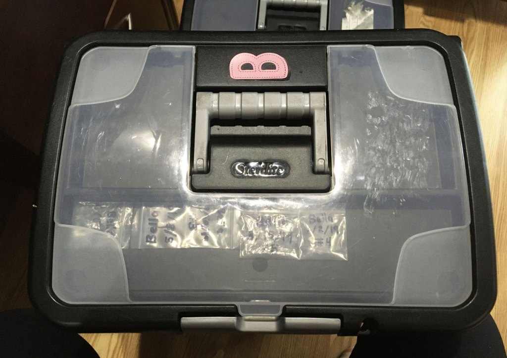 plastic file organizer box with pink B sticker on top