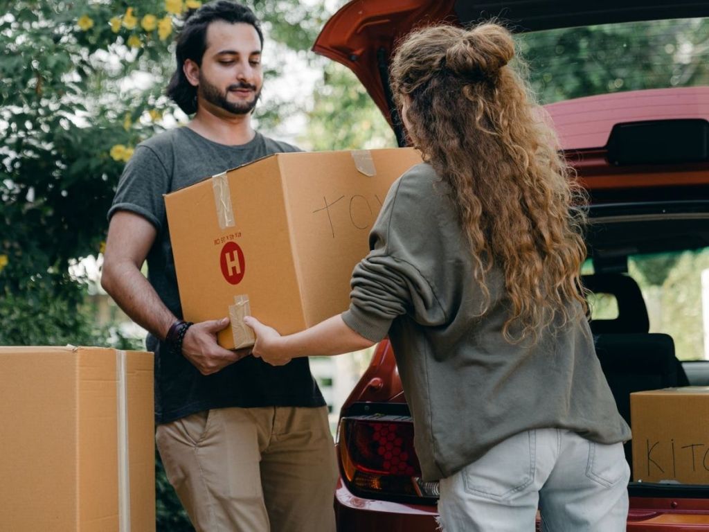 couple loading car with moving boxes