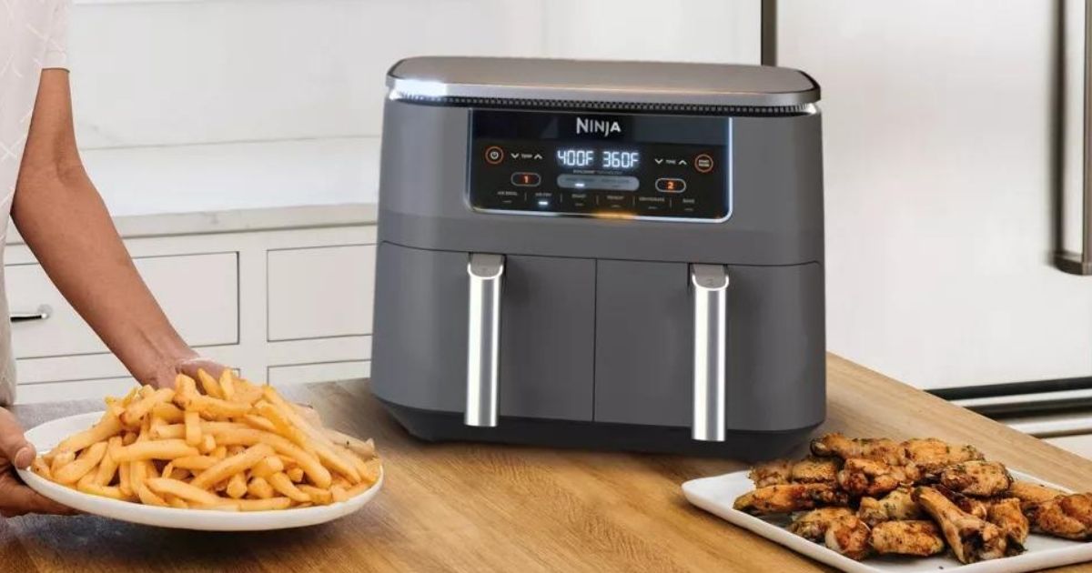 woman putting a plate of fries by an air fryer
