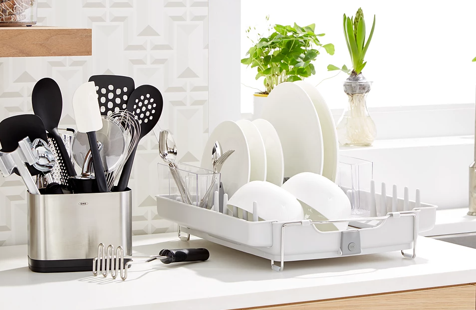 OXO utensil set next to dishes in a rack