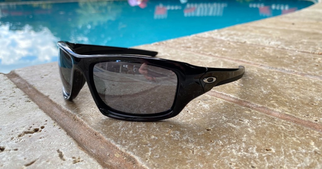 pair of sunglasses sitting next to pool
