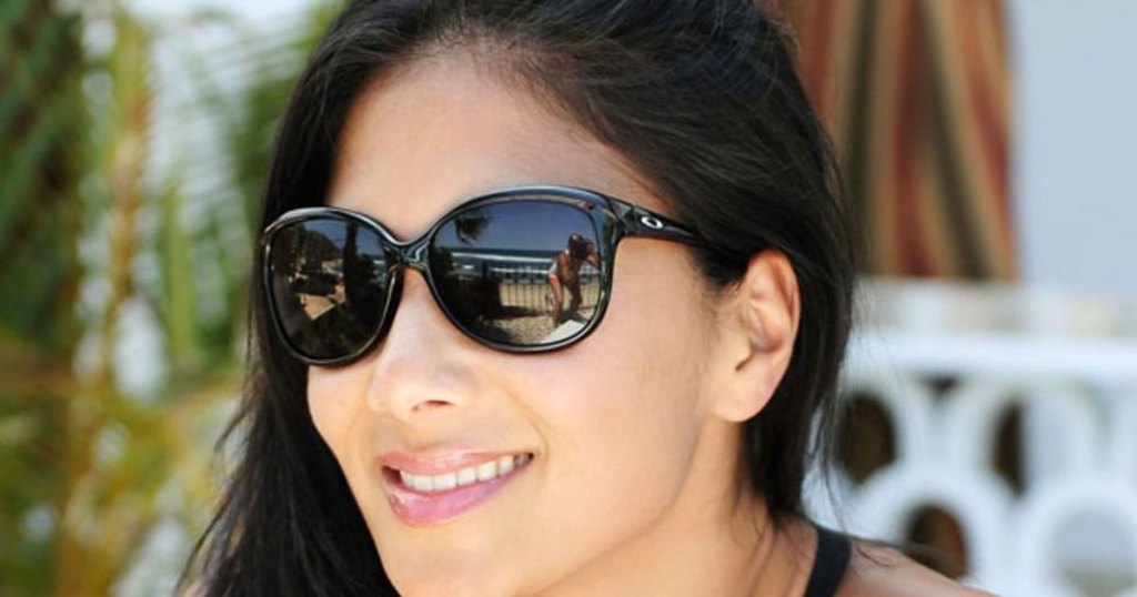 woman wearing a pair of black oakley sunglasses