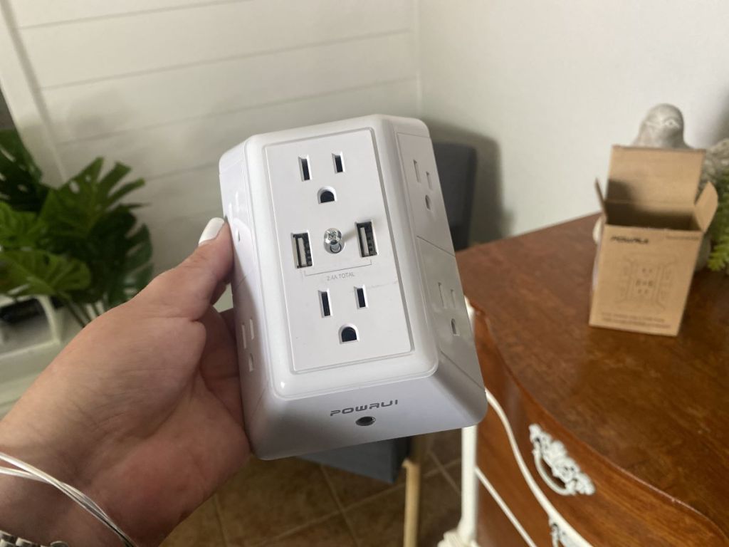hand holding a wall charger