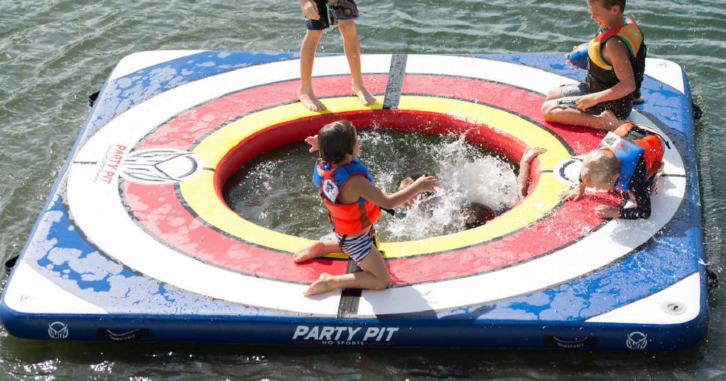 kids playing on large party pad float in lake