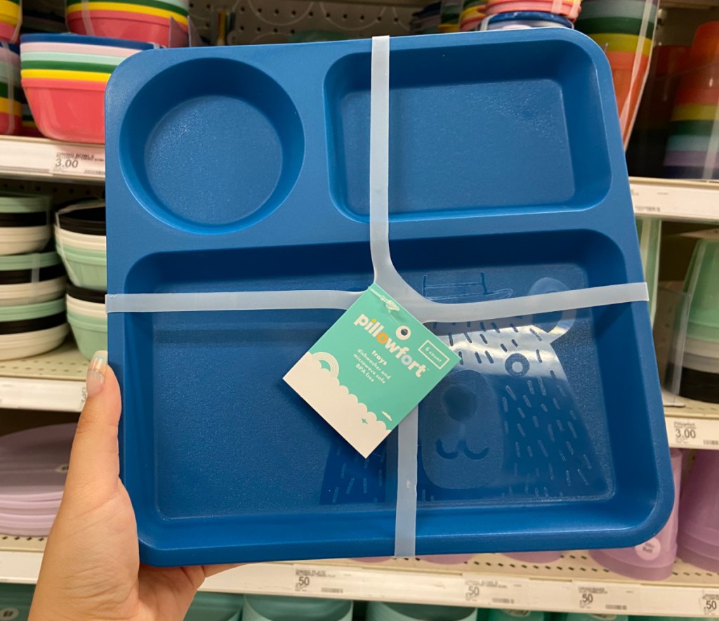 hand holding stack of kids trays