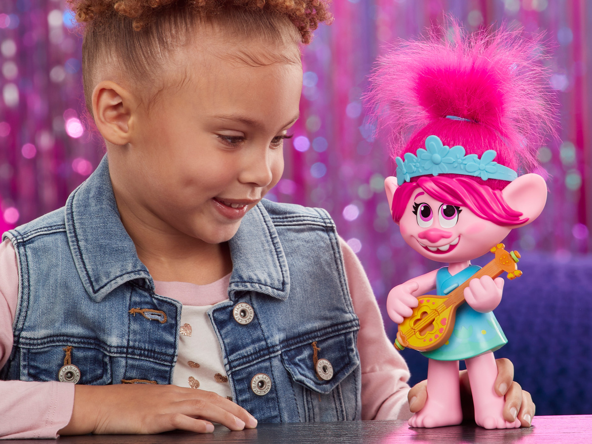 girl playing with pink trolls doll