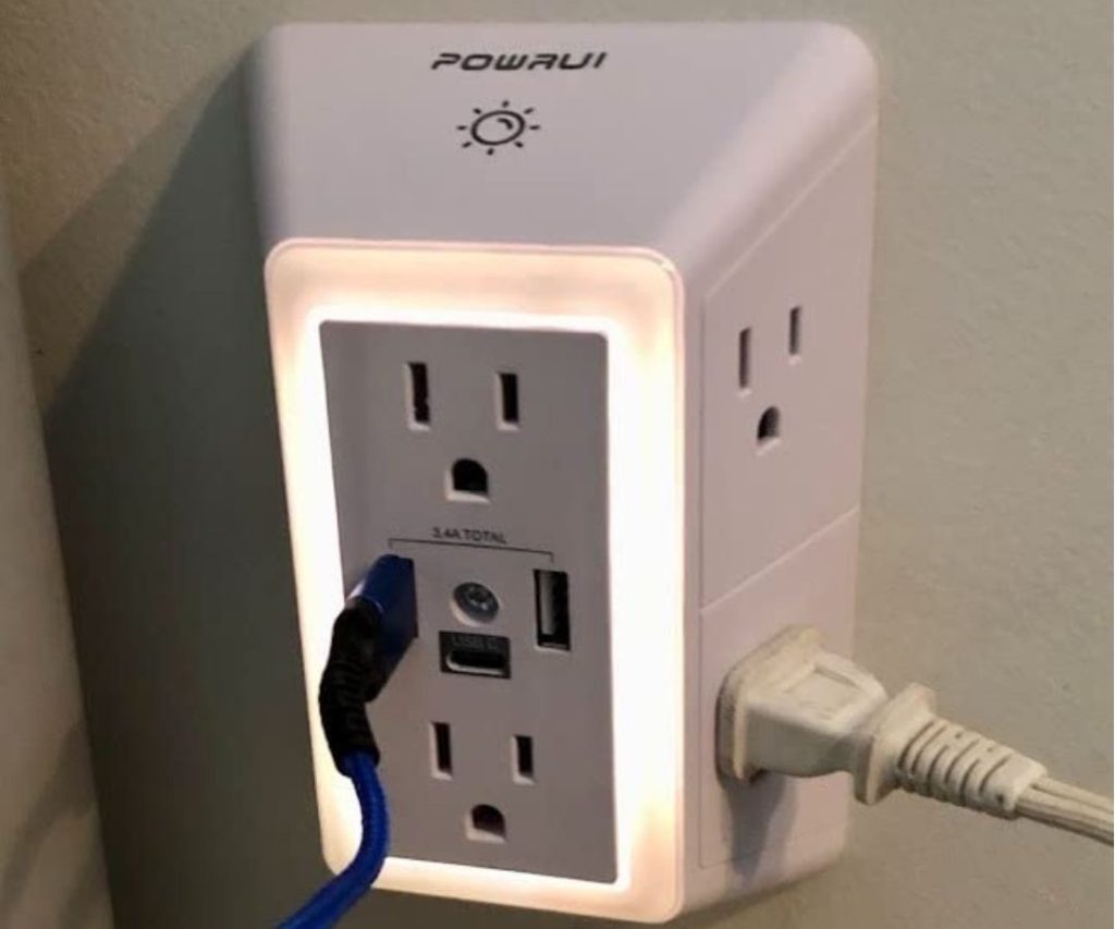 PowerUI Outlet Extender with a cord and a cable plugged into it