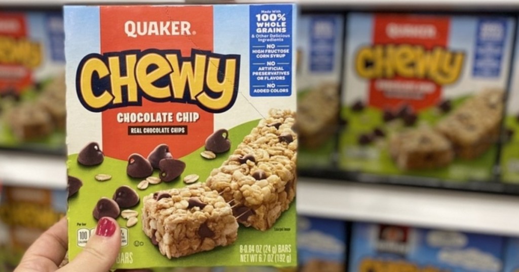 holding a box of Quaker chewy granola bars