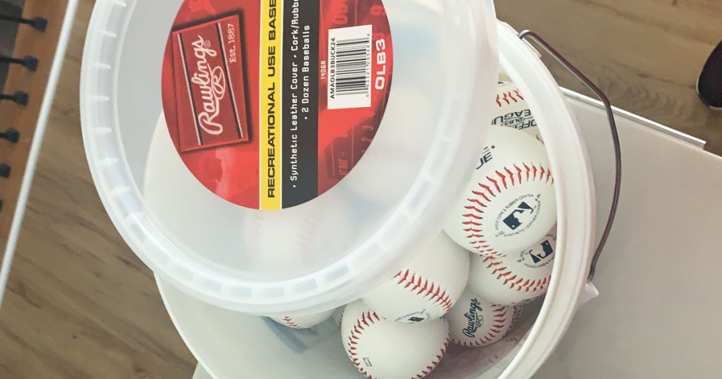 plastic bucket filled with baseballs