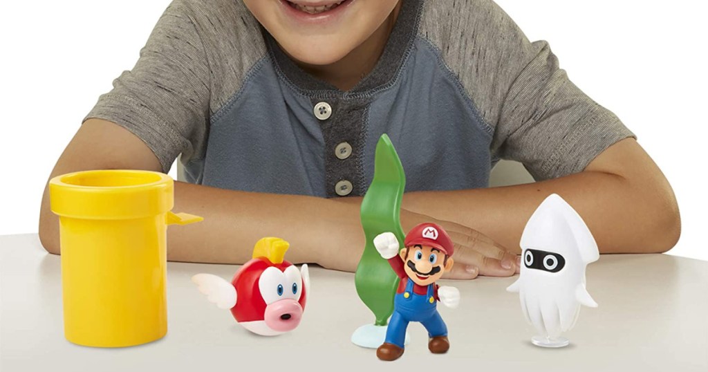 kid playing with Super Mario Brothers toys