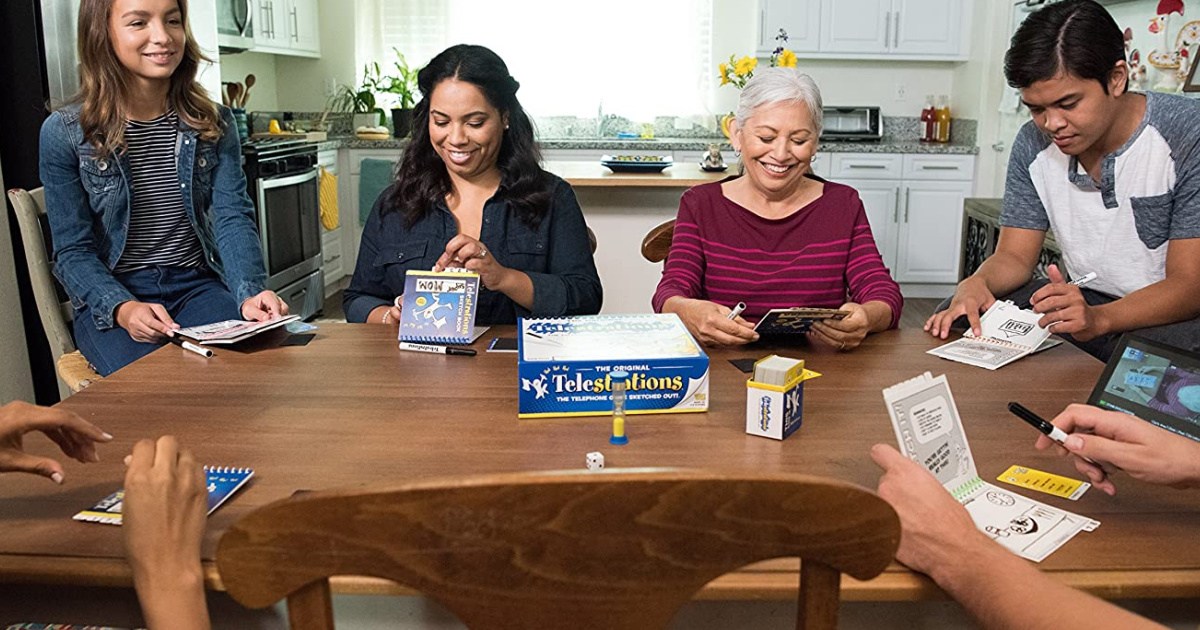 family playing Telestrations the board game