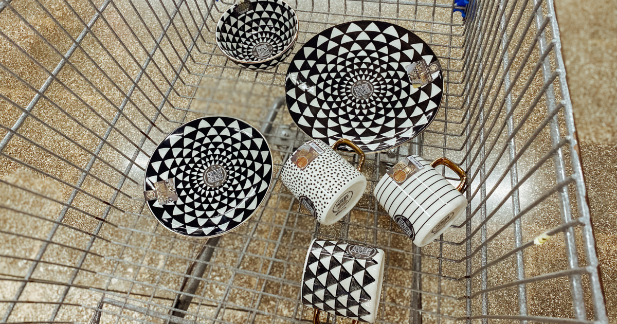 collection of black and white dinnerware pieces in a store shopping cart