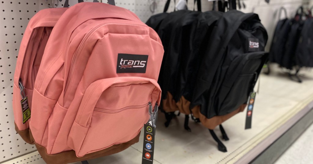 pink and black backpack hanging on rack 