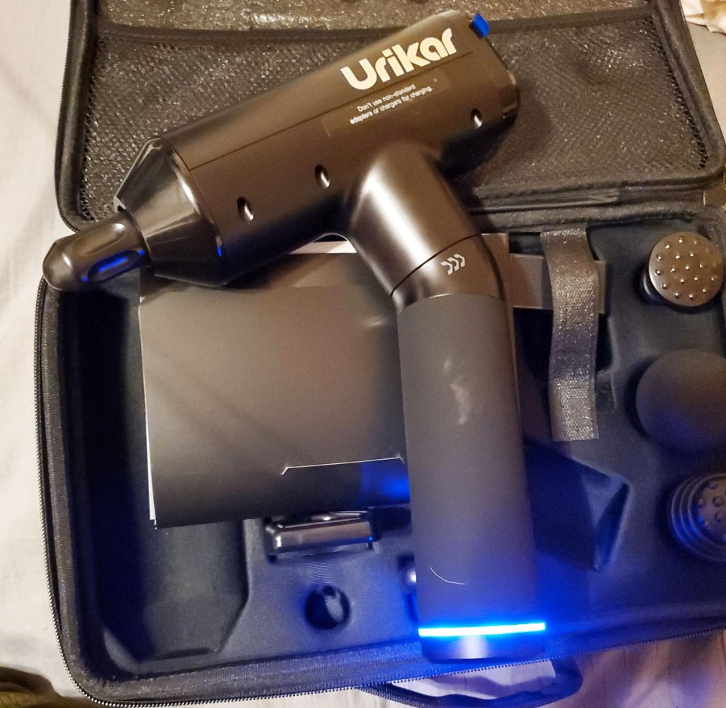 massage gun on top of its carry case