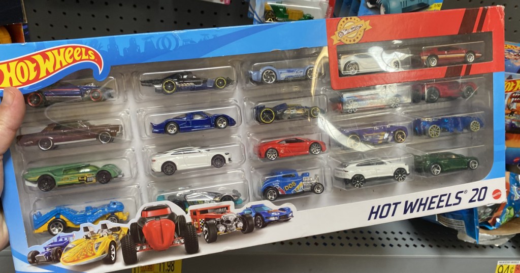 hand holding a hot wheels box of cars