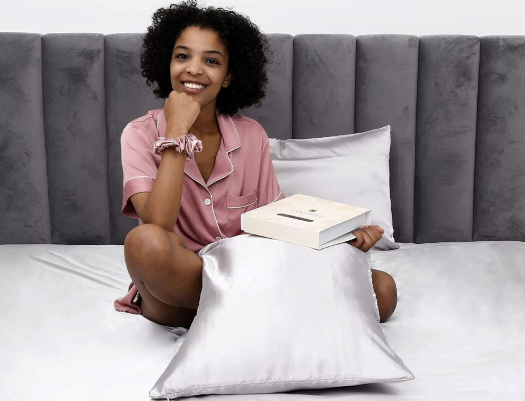 woman holding a box and a pillow