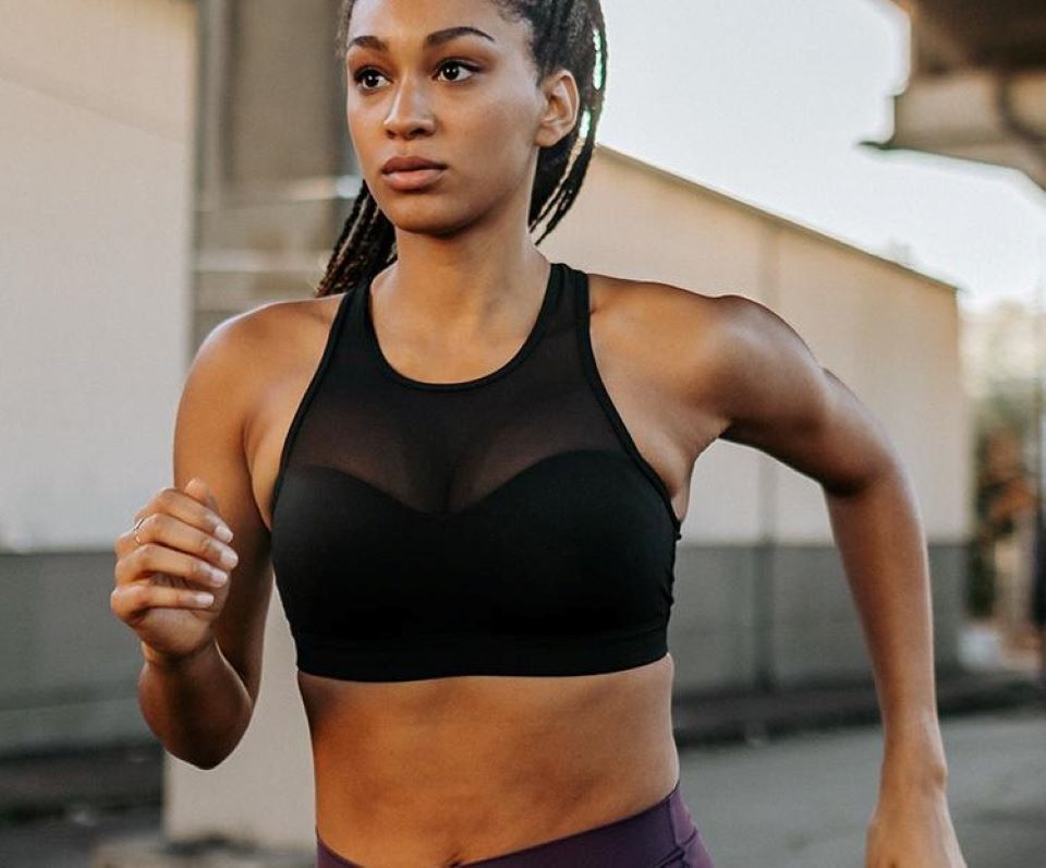 woman running in a sports bra