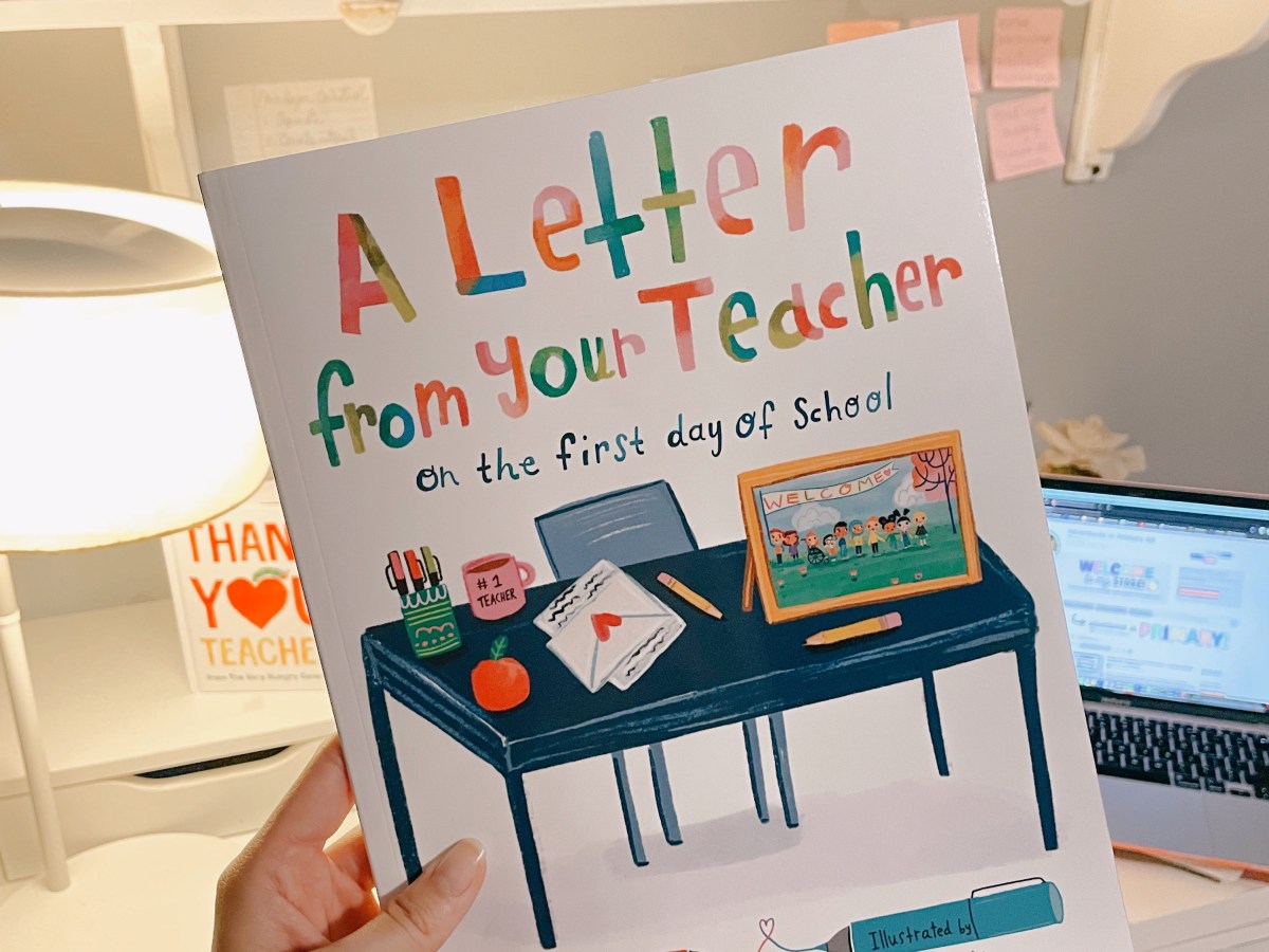 holding 'A Letter From Your Teacher' book