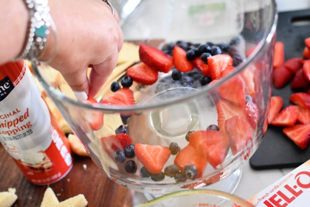 adding berries to trifle dish