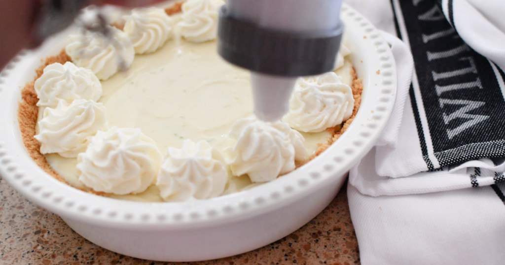 adding whipped cream to pie using wilton decorator tool