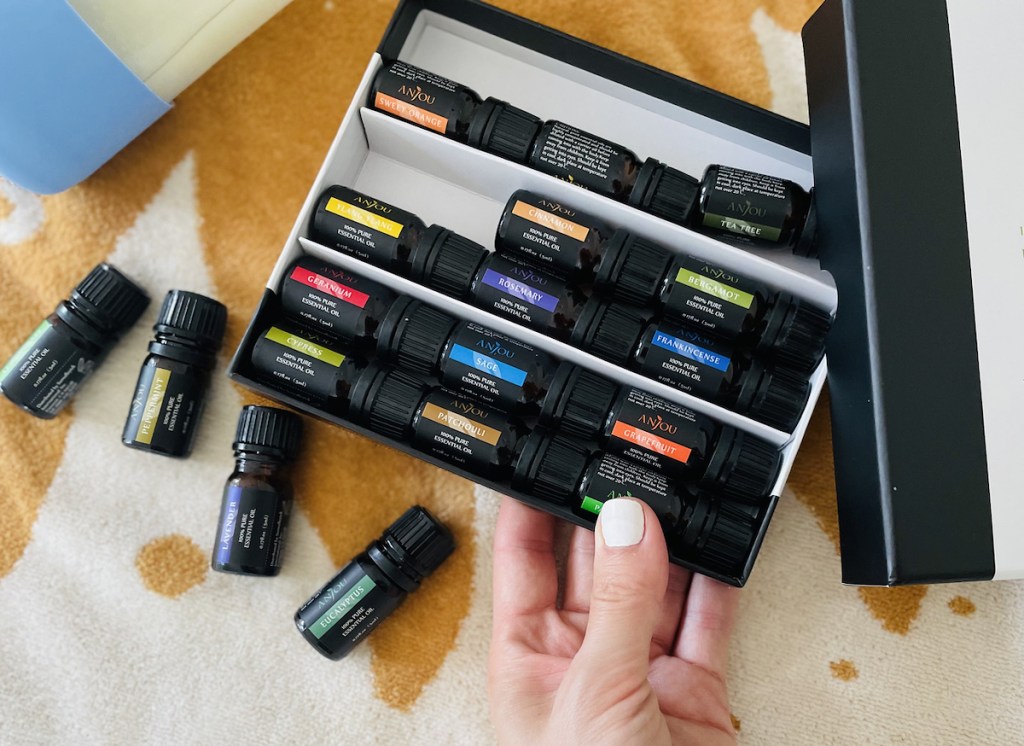 hand holding box of essential oils