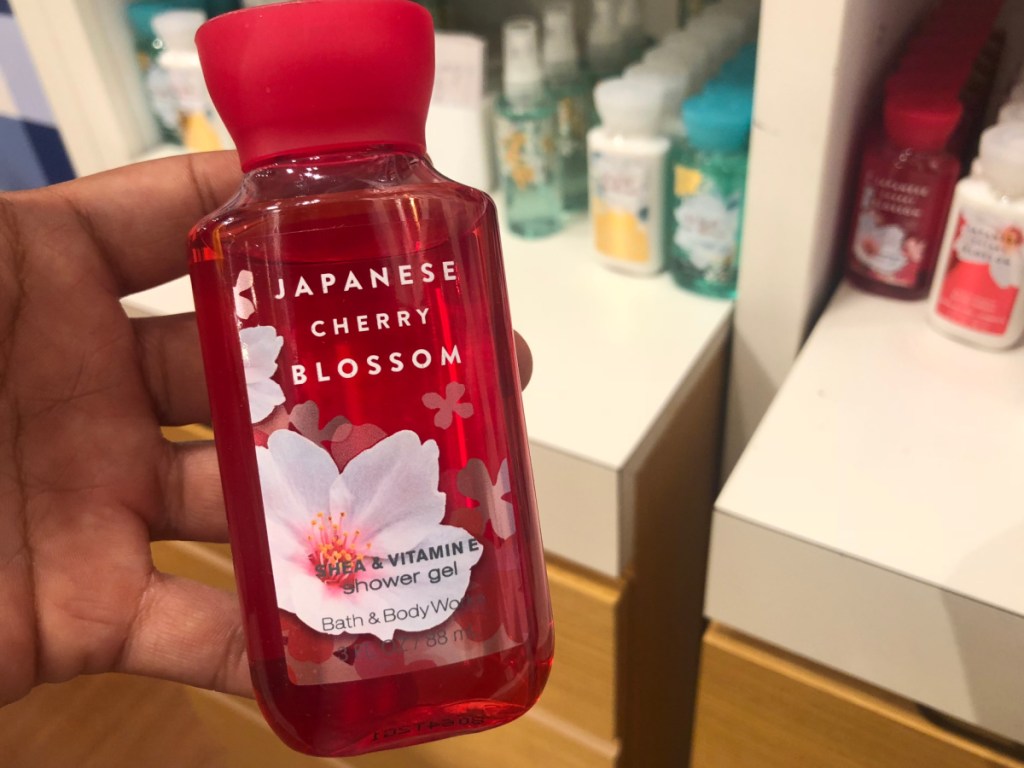 hand holding bottle of body wash in store