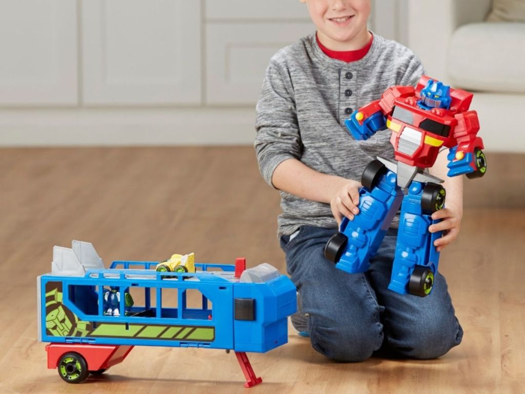 boy playing with Transformer toys