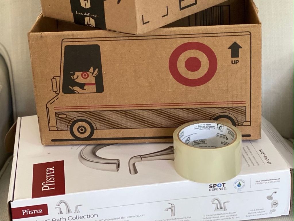 opened Amazon, Target, and Pfister boxes and roll of tape