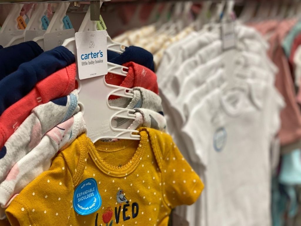 Carters bodysuits hanging in store