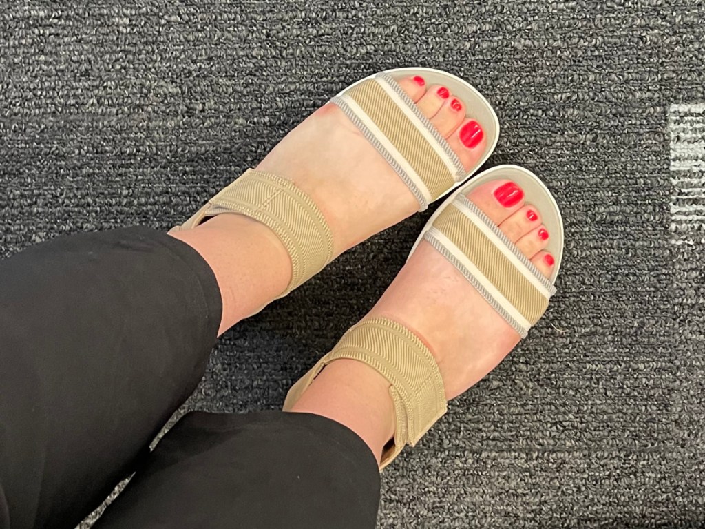 feet wearing tan colored sandals