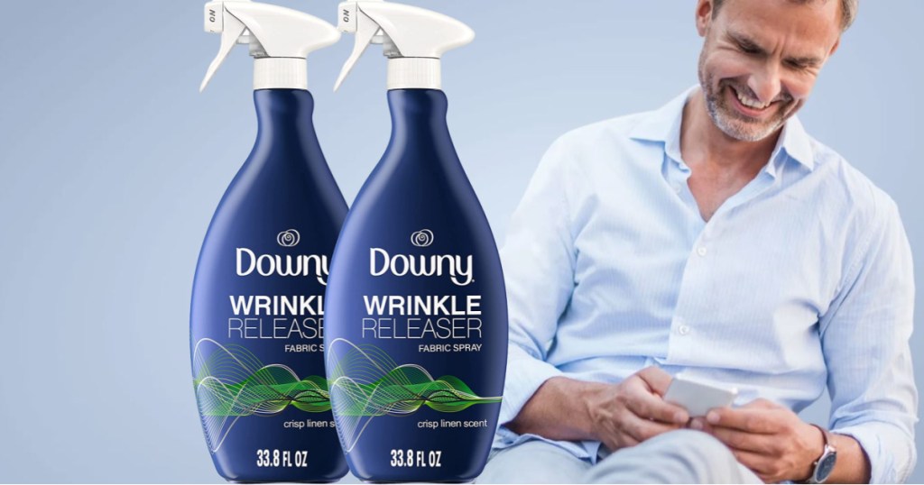 man in dress shirt looking at phone with 2 bottles of downy imposed in front