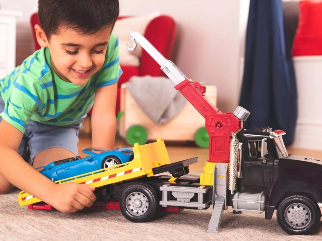 boy playing with toy tow truck