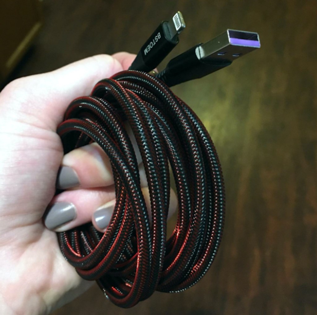 hand holding coiled black and red phone charger - gifts for new moms