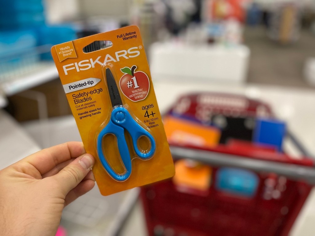 holding children's scissors at Target