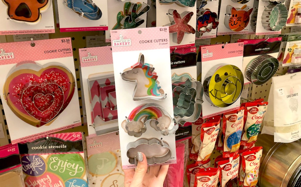 hand holding unicorn and rainbow cookie cutters in hobby lobby sale schedule aisle